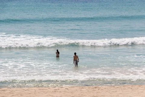 Persons going in the sea Stock Photos