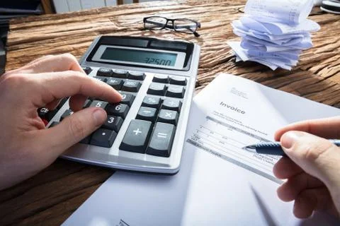 Person's Hand Calculating Invoice Stock Photos
