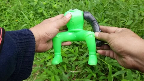 A person's hand examines a broken plastic doll. Children's toy puppet Stock Footage 296420800