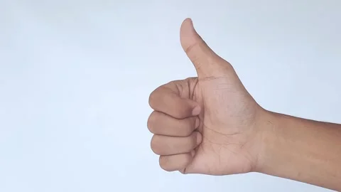 A person's hand giving a thumbs up in a white background Stock Footage 289201423