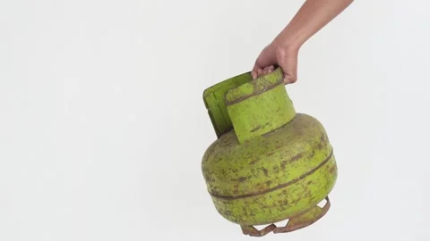 A person's hand is holding a 3 kg LPG gas cylinder. Video stock 337302502