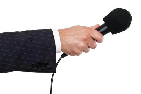 Person's hand holding a microphone Stock Photos