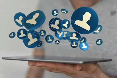 A person's hand holding a tablet with 3D rendered people silhouettes in the n Fotos de archivo