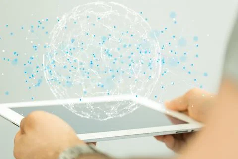 Person's hand holding a tablet with 3D rendered futuristic globe and data Foto stock