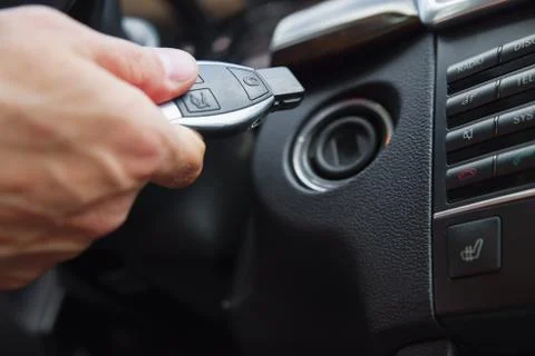 Person's Hand Inserting Key To Start Car Stock Photos