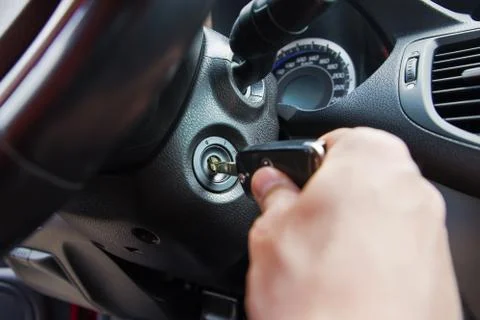 Person's Hand Inserting Key To Start Car Stock Photos
