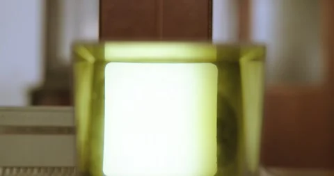 A person's hand inserts slides into a small lighted projector with a Stock Footage 245988214