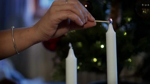 A person's hand lighting a candle with a match Video stock 220739464