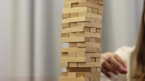 A person's hand moves a chess piece on a wooden chessboard Stock Footage 278886664
