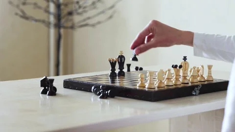 A person's hand moves a chess piece on a board Stock Footage 278900741