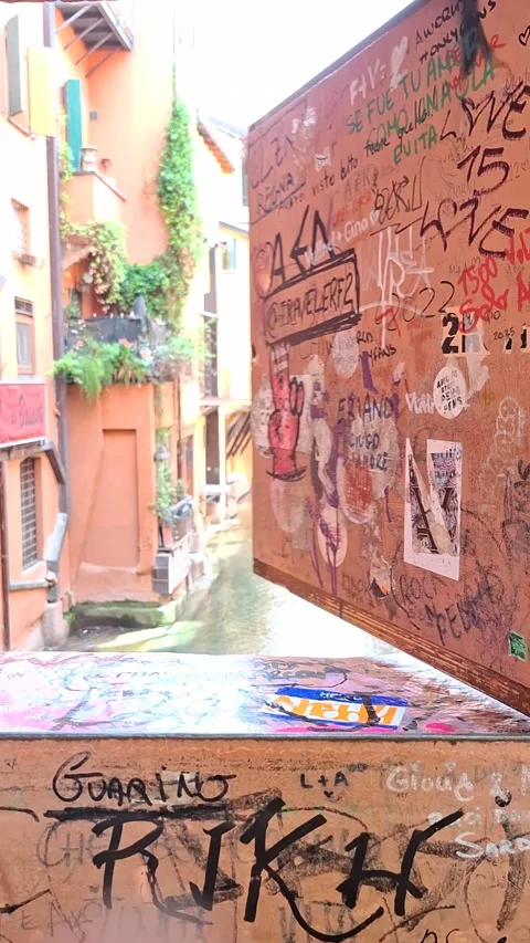 Person's hand opening hidden window revealing a view of a Canal in Bologna Stock Footage 344669957