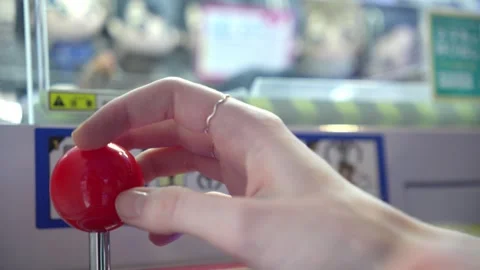 Person's hand operating a claw machine joystick 스톡 동영상 340253638