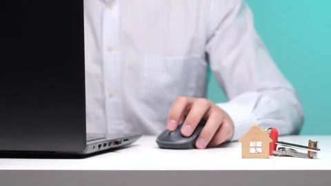 Person's hand operating a computer mouse, using a laptop to search for a new Stock Footage 342769979