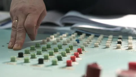 A person's hand is operating a control panel with numerous buttons and switch Stock Footage 331252022