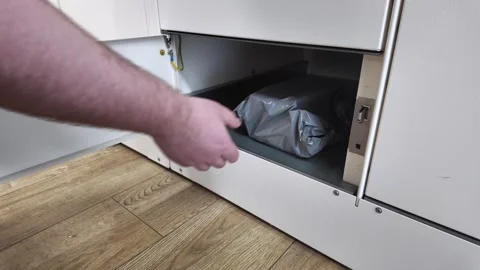 Person's hand placing a gray package into an open white locker, illustratin.. Stock Footage 310902776