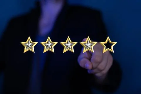 Person's hand pointing at hovering stars. Rating, evaluation. Stock Photos