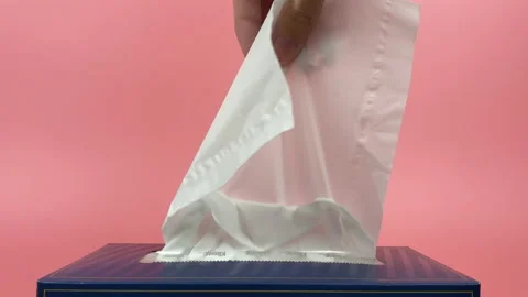 A person's hand pull out a piece of tissue from tissue paper box isolated. Stock Footage 201348939