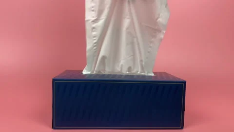 A person's hand pull out a piece of tissue from tissue paper box isolated. Stock Footage 201349176