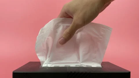 A person's hand pull out a piece of tissue from tissue paper box isolated. Stock Footage 201365937