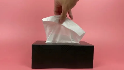 A person's hand pull out a piece of tissue from tissue paper box isolated. Stock Footage 201366058