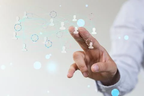 Person's hand touching 3D rendered people silhouettes Fotos de archivo