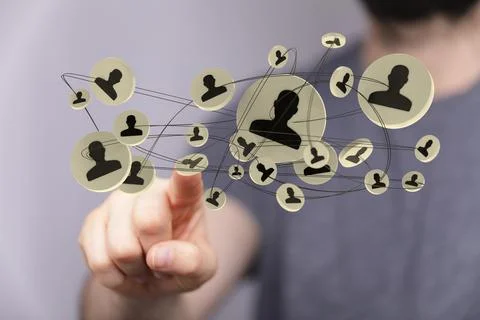 Person's hand touching 3D rendered people silhouettes Fotos de archivo