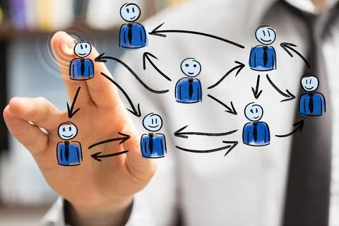Person's hand touching the 3D rendered people silhouettes in the network team Fotos de archivo