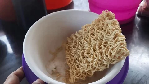Person's Hand Touching Dry Instant Noodles in White Bowl Stock Footage 310289159