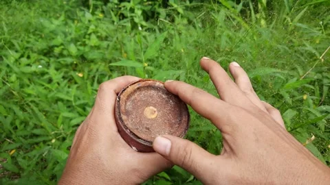 A person's hand tries to open a rusty paint can Stock Footage 296340649