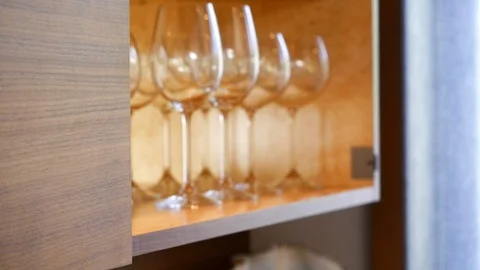 A person's hand uses touch-open, walnut kitchen cabinets. Stock Footage 98013739