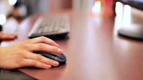 Persons hand using computer mouse, working on a desk in a modern office setup Stock Footage 320520267