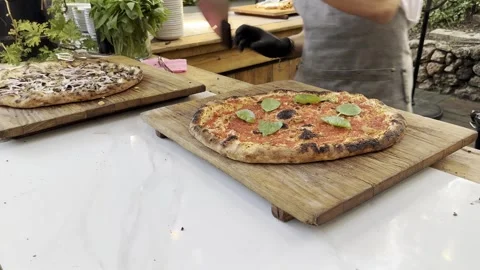 Person's hands in black gloves cut pizza by special knife. Stock Footage 245339918