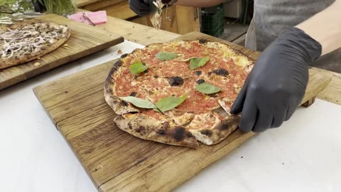Person's hands in black gloves cut pizza by special knife. Stock Footage 245340005