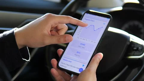 A persons hands carefully study performance metrics and graph data within a Stock Footage 316387156