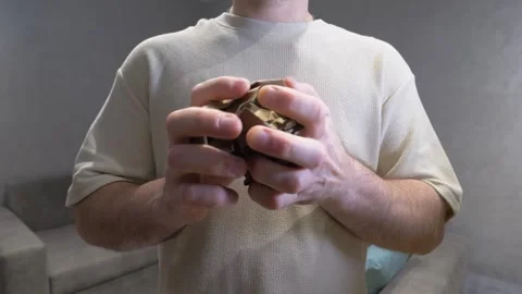 A person's hands crumpling a sheet of paper into a tight ball Stock Footage 340209120