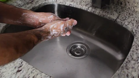 A person's hands doing the proper hand washing process Stock Footage 126617501