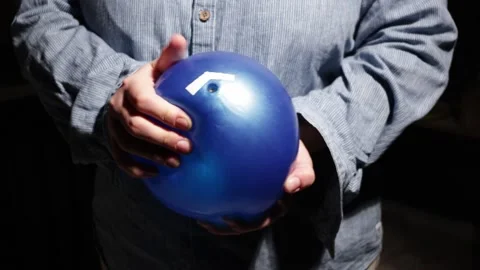 Person's hands holding a blue balloon with a white sticker on it Stock Footage 339176952