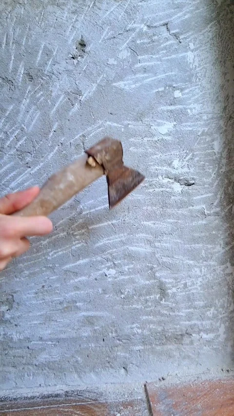 A person's hands holding a rusty axe with a wooden handle. Stock Footage 286005829