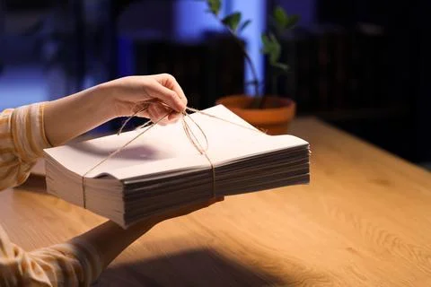 Persons hands holding stack of white paper tied with twine, office work and d Stock Photos