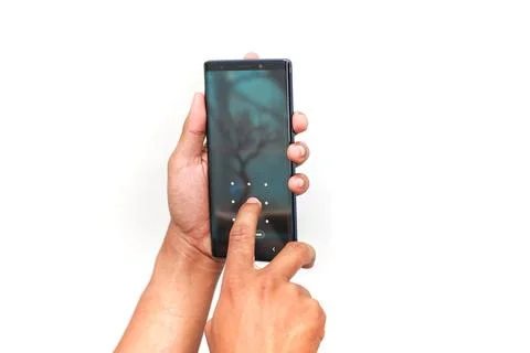 Person's Hands Operating A Smartphone With A Dark Forest Scene Wallpaper Is.. Stock Photos