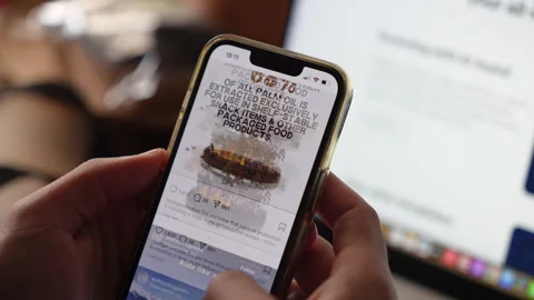 Person's hands scrolling through the popular Instagram Social media app Stock Footage 304169651