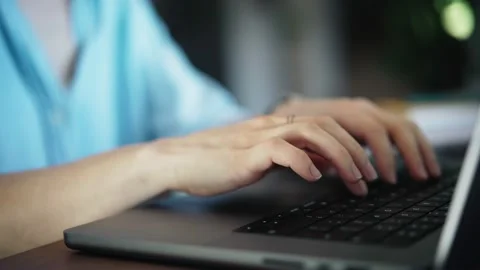A persons hands typing on a laptop keyboard. Stock Footage 233776103