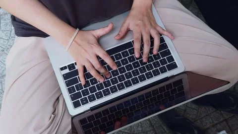 Person's hands typing on laptop keyboard, engaging with technology, studying, Video stock 334458361