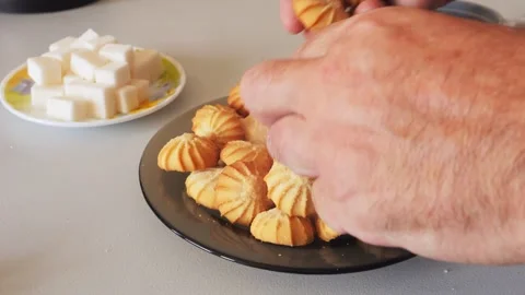A persons hands unscrew sweets from a plate on the table Stock Footage 319577853