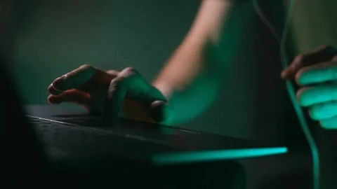 Person's hands using laptop touchpad at night Stock Footage 337830630