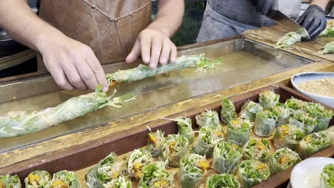 Person's hands wraps up roll with greens and stuffing in cling film. Stock Footage 245339885