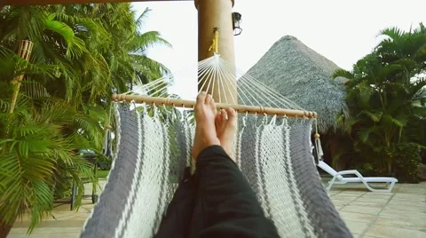 Person's legs resting on Hammock at beautiful vacation spot Stock Footage 49141498
