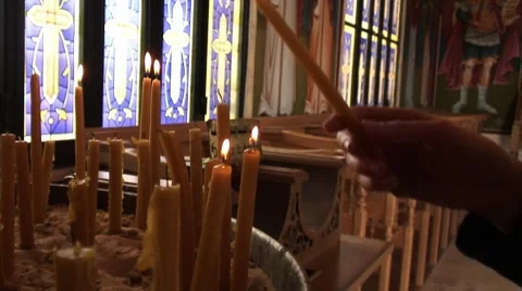 Persons lights candle and donates Stock Footage 8691280