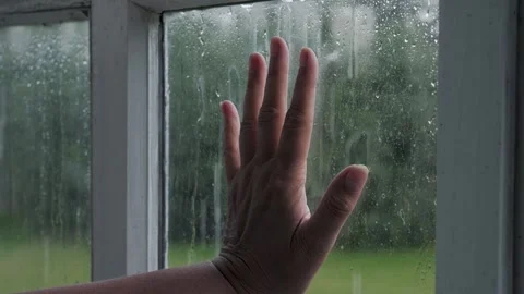 Persons lonely hand sliding down rainy window Stock Footage 333378639