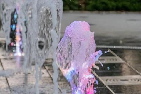 Persons reflection on a glossy surface in a vibrant, firework-like urban se.. Stock Photos